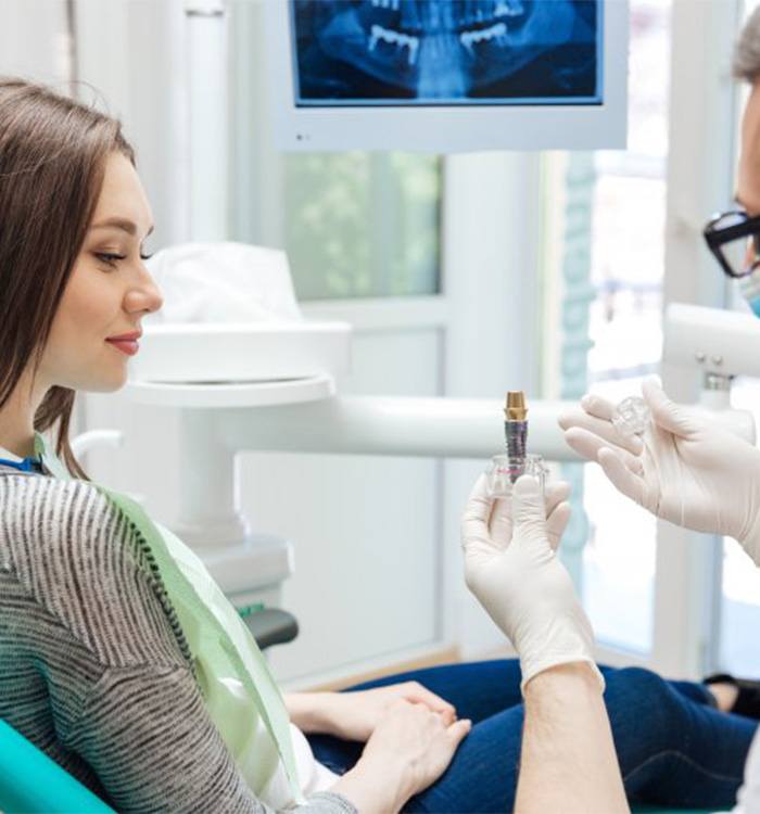 Patient in Montpelier smiling talking to dentist about dental implants