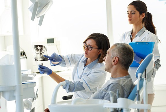 Patient in Montpelier smiling talking to dentist about dental implants