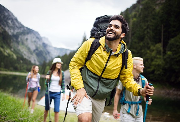 Group of friends hiking along lake